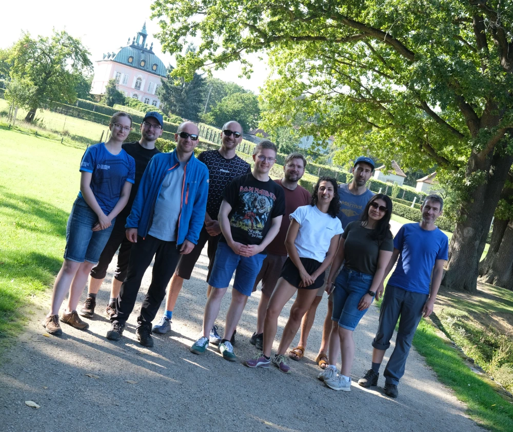 Group photo of the PIKOBYTES team. In the background idyllic greenery.